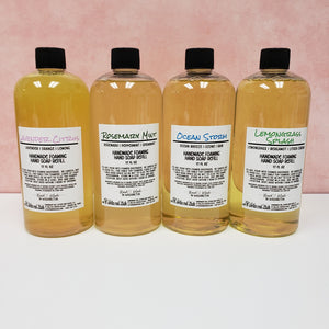 Foaming Hand Soap Refill Bottles.  17 Fl Oz.  Four scents pictured, Lavender Citrus, Rosemary Mint, Ocean Storm, and Lemongrass Splash in clear bottles with black caps.